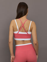 Model wears a white with rosewood overlay sports bra perfect for medium impact activities. 