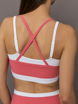 Model wears a white with rosewood overlay sports bra perfect for medium impact activities. 