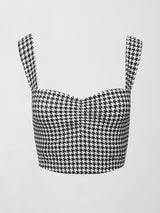 Flat lay of houndstooth sports bra with wide straps and ruched front detail.