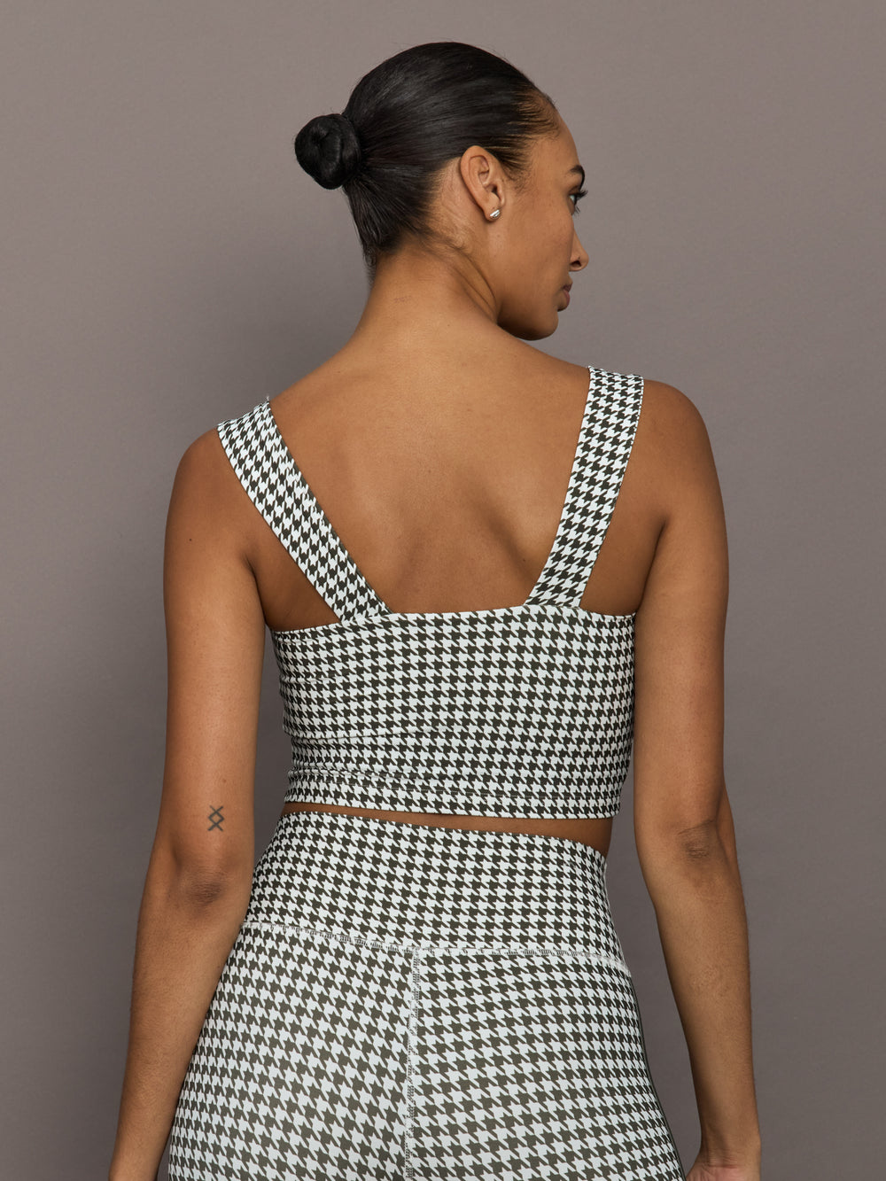 Back view of houndstooth sports bra with square neckline and wide straps.