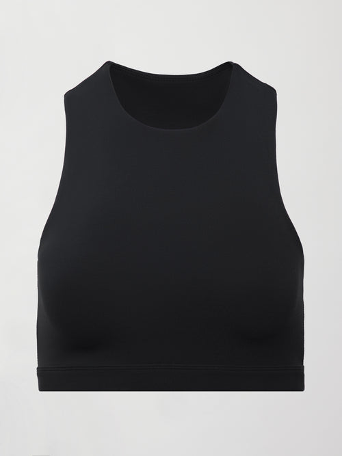 A cropped black athleisure tank with an asymmetrical racerback. 