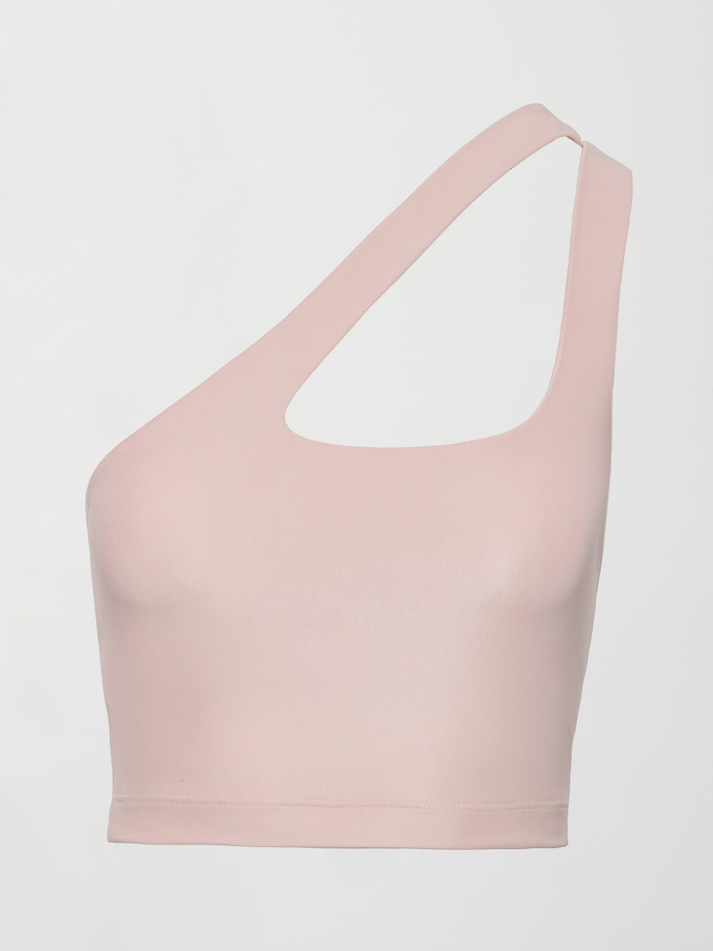Model wears shiny, asymmetrical one-shoulder bra top in light pink, with a smooth, reflective fabric.