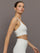 Model wears white active bra with double thin back straps and a smooth, supportive finish.
