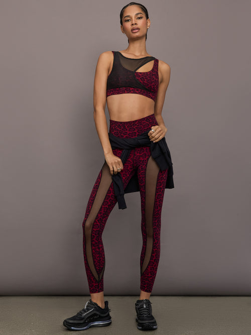Model is wearing Melt sheer spliced leggings in red leopard, styled set full body.