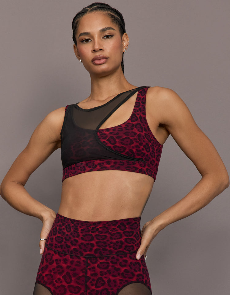 Model is wearing the Mesh Overlay Bra in Red Leopard, front view.