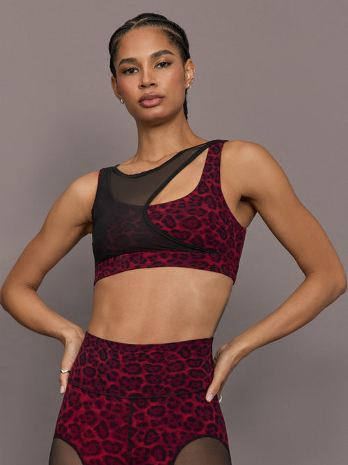 Model is wearing the Mesh Overlay Bra in Red Leopard, front view.