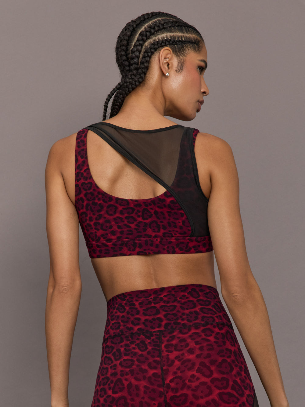 Model is wearing the Mesh Overlay Bra in Red Leopard, back view.