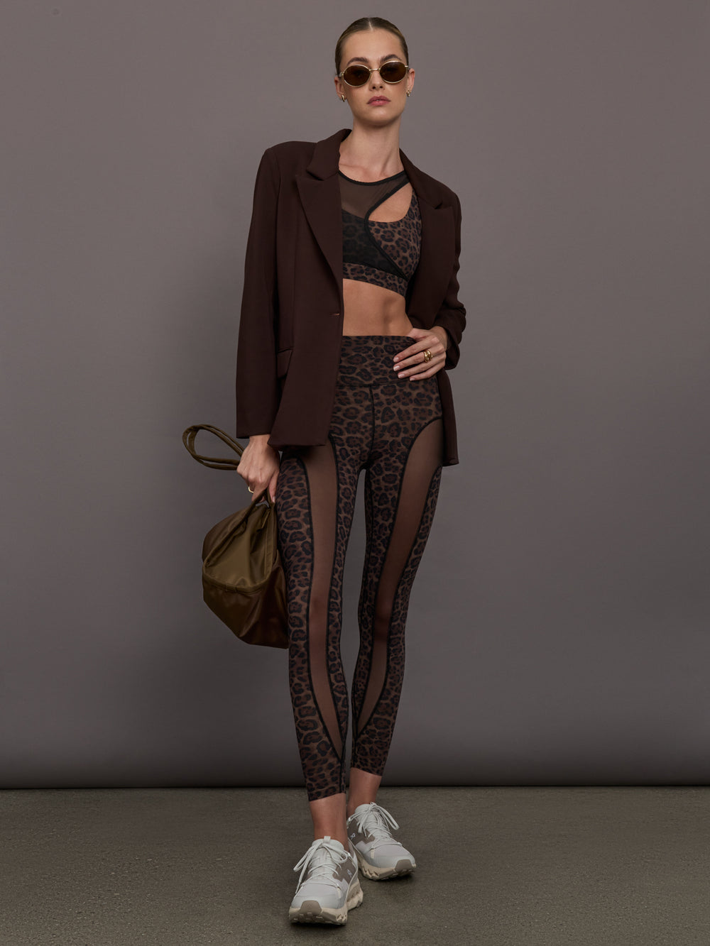 Model wearing a leopard print sports bra with a mesh overlay