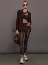 Model wearing a leopard print sports bra with a mesh overlay