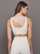 Model wears Snow leopard sports bra with a white mesh overlay, featuring a scoop neckline, wide straps.