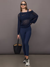 Model wears Black sports bra with double straps on one side and a square neck.