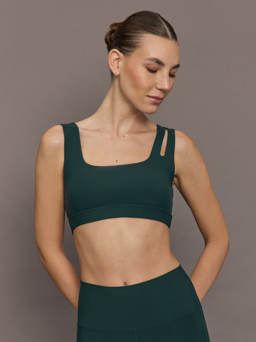 Model is wearing the Cutout Bra in Melt Forest, front view.