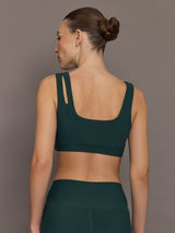 Model is wearing the Cutout Bra in Melt Forest, back view.