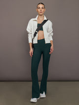 Model is wearing the Cutout Bra in Melt Forest, full body view styled with matching pants and zip jacket.