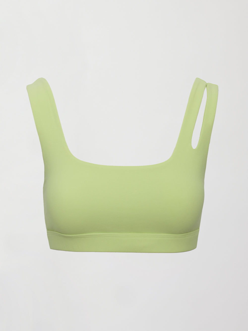 Model wearing a light green cutout sports bra.