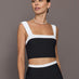 Model is wearing a black and white square-neck longline contrast bra top with wide straps, front view.