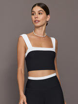 Model is wearing a black and white square-neck longline contrast bra top with wide straps, front view.