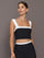 Model is wearing a black and white square-neck longline contrast bra top with wide straps, front view.
