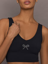 Close-up of Rhinestone Bow Bra in Melt Black highlighting rhinestone bow embellishment on chest.