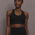 Model is wearing Diamond Compression Support Sports Bra in Black, front view.