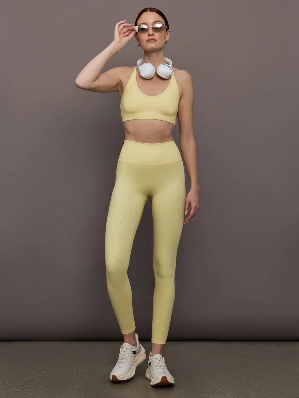 Model is wearing Melt Rib High Rise Legging in Banana, full body styled with matching set.