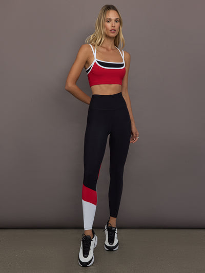Model is wearing Melt Double Layered Sports Bra in Black, Crimson, and White Binding, full body front view styled with leggings.