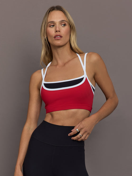 Model is wearing Melt Double Layered Sports Bra in Black, Crimson, and White Binding, front view.