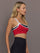 Model is wearing Melt Double Layered Sports Bra in Black, Crimson, and White Binding, side view showing layered neckline.