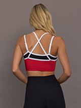 Model is wearing Melt Double Layered Sports Bra in Black, Crimson, and White Binding, back view with crossed adjustable straps.