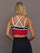Model is wearing Melt Double Layered Sports Bra in Black, Crimson, and White Binding, back view with crossed adjustable straps.