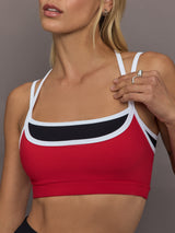 Model is wearing Melt Double Layered Sports Bra in Black, Crimson, and White Binding, close-up of contrast binding detail.