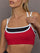 Model is wearing Melt Double Layered Sports Bra in Black, Crimson, and White Binding, close-up of contrast binding detail.
