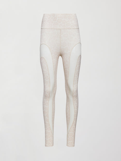 Model wears snow leopard leggings with sheer mesh spliced panels along the legs, a high-rise waistband, and a sleek, form-fitting silhouette.
