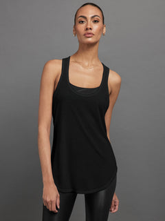 Model wears black long racerback tank top with a loose fit and scoop neckline.




