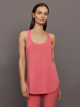 Model wears long racerback rosewood colored tank top with a loose fit and scoop neckline.