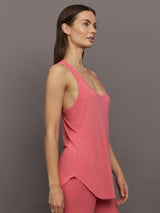 Model wears long racerback rosewood colored tank top with a loose fit and scoop neckline.