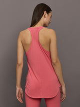 Model wears long racerback rosewood colored tank top with a loose fit and scoop neckline.