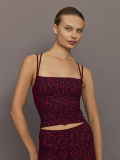 Model wearing Melt strappy tank in red leopard, cropped square neckline front close-up.
