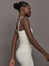 Model wears a buttery soft athleisure double strapped tank with cross back in a snow leopard print. 