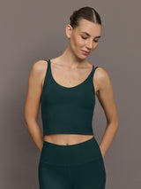 Model is wearing the V Neck Tank in Forest, front view.