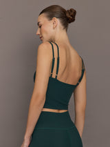 Model is wearing the V Neck Tank in Forest, side profile.