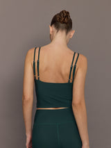 Model is wearing the V Neck Tank in Forest, back view.