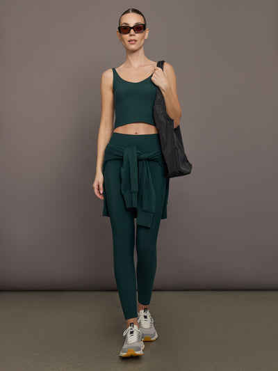 Model is wearing the V Neck Tank in Forest, full body view.