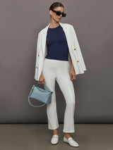 Model wears a lightweight navy high neck ribbed tank. 