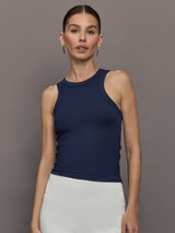 Model wears a lightweight navy high neck ribbed tank. 