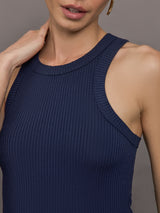 Model wears a lightweight navy high neck ribbed tank. 
