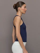 Model wears a lightweight navy high neck ribbed tank. 