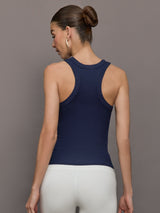 Model wears a lightweight navy high neck ribbed tank. 