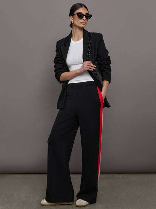 Model wears a white high neck ribbed jersey tank. 