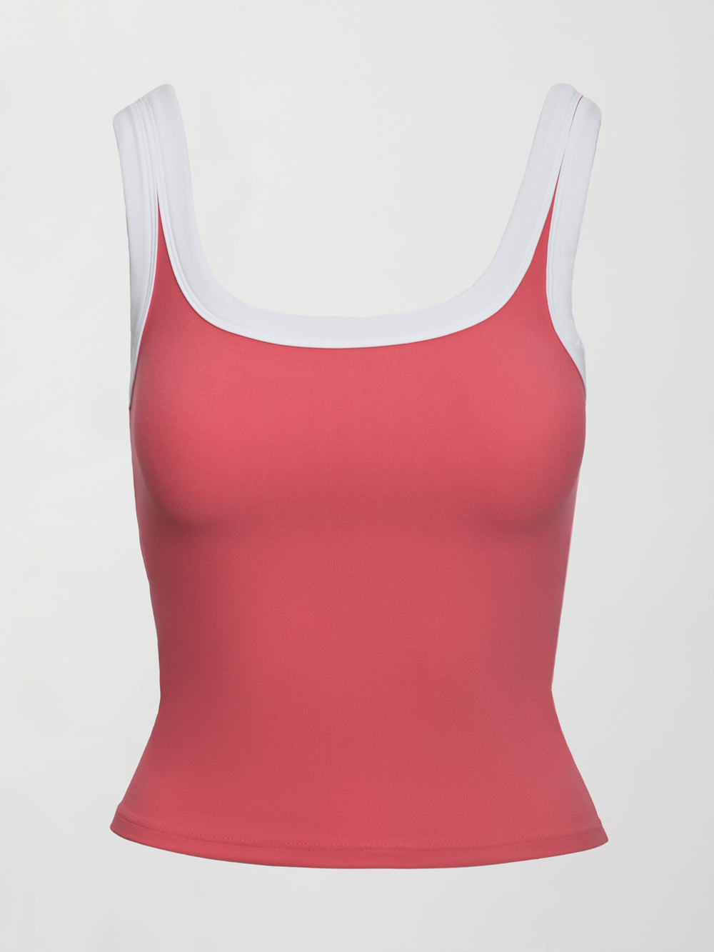 Model wears a rosewood colored tank top with thick white straps and a scoop tank neckline.